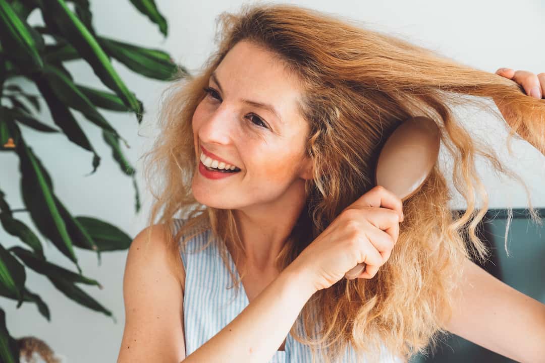 Femme lisser cheveux avec brosse lissante